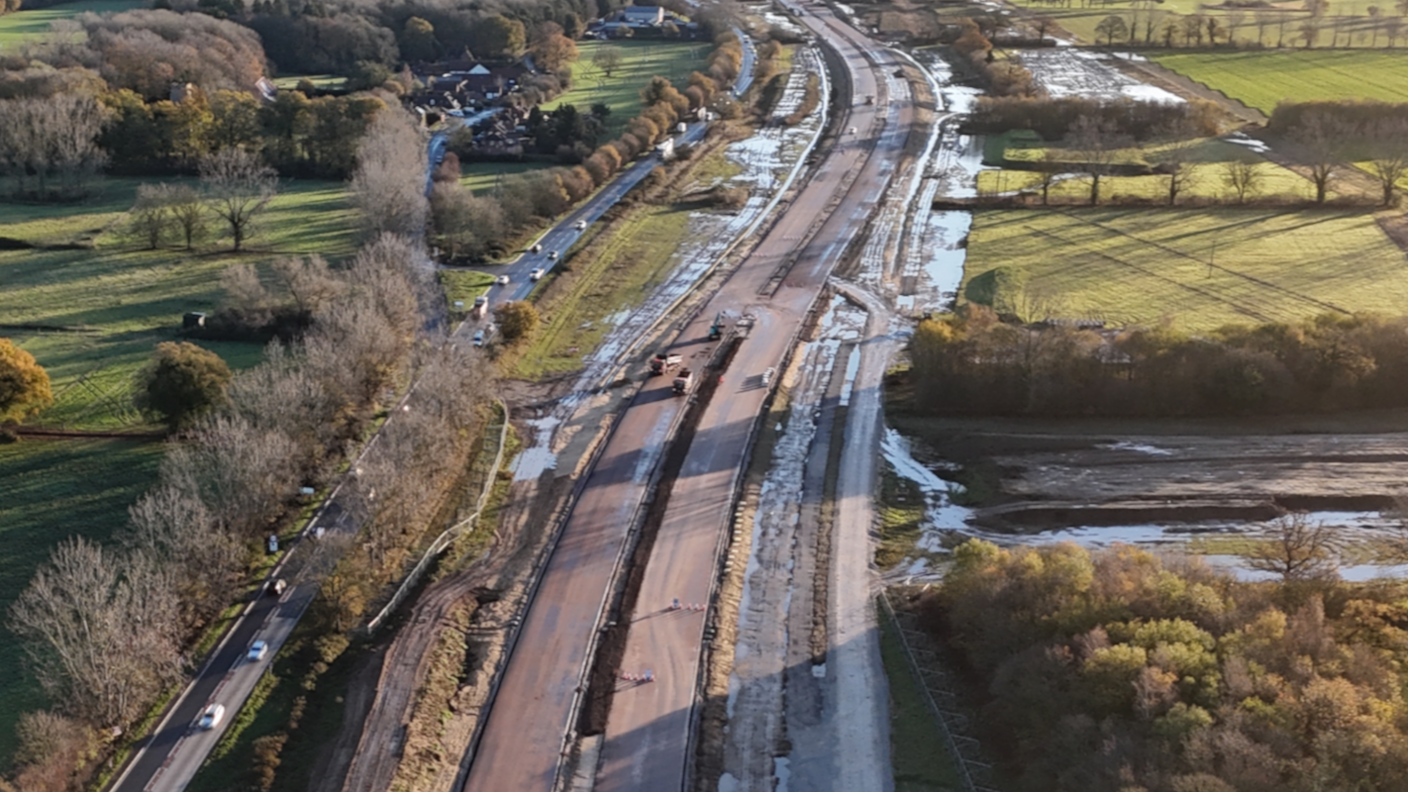 A drone photograph of the A47 work at Blofield. To the left is the existing single-carriageway road. Next to it are the new carriageways, still under construction. There is a lot of standing water following heavy rain.