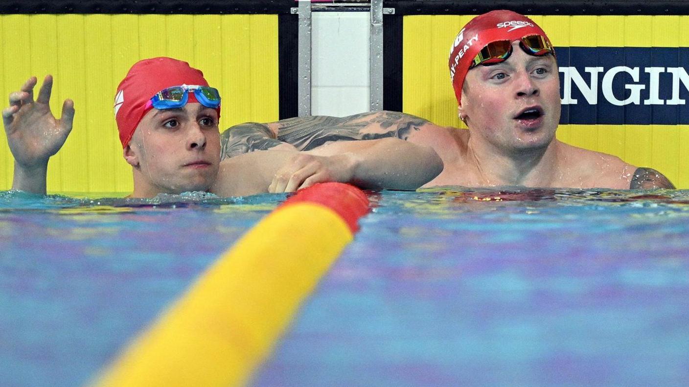 Filip Nowack (left) and world record holder Adam Ramsay-Peaty in the pool after their semi-final