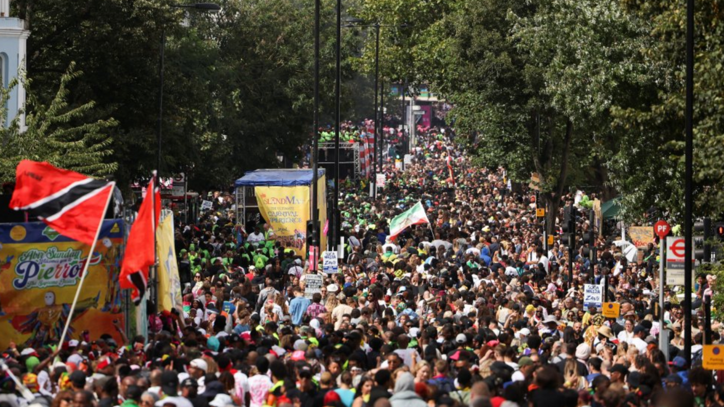 Revellers attend Notting Hill Carnival, in London, with huge crowds gathering for the annual celebration