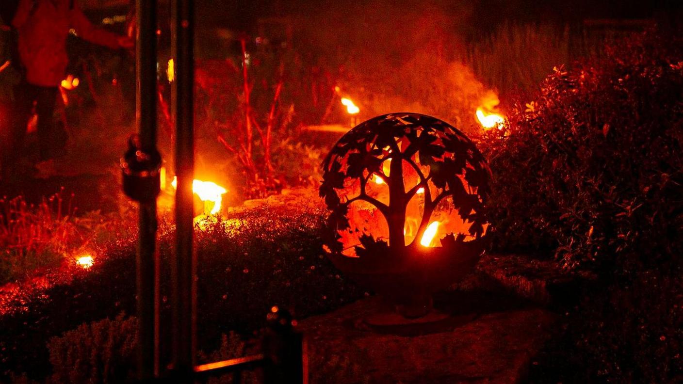 A carved pumpkin lit up by fire