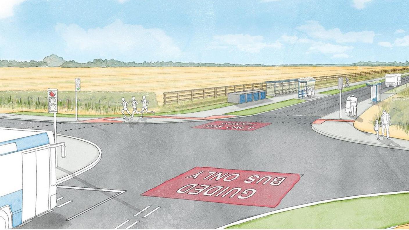 Artist's impression of a crossroads junction. Two exits have the words GUIDED BUS ONLY painted in a red box on the road surface. Two bus stops are on one side of the road and blue storage boxes are next to one of them. A number of people are walking or running on an adjacent path. 