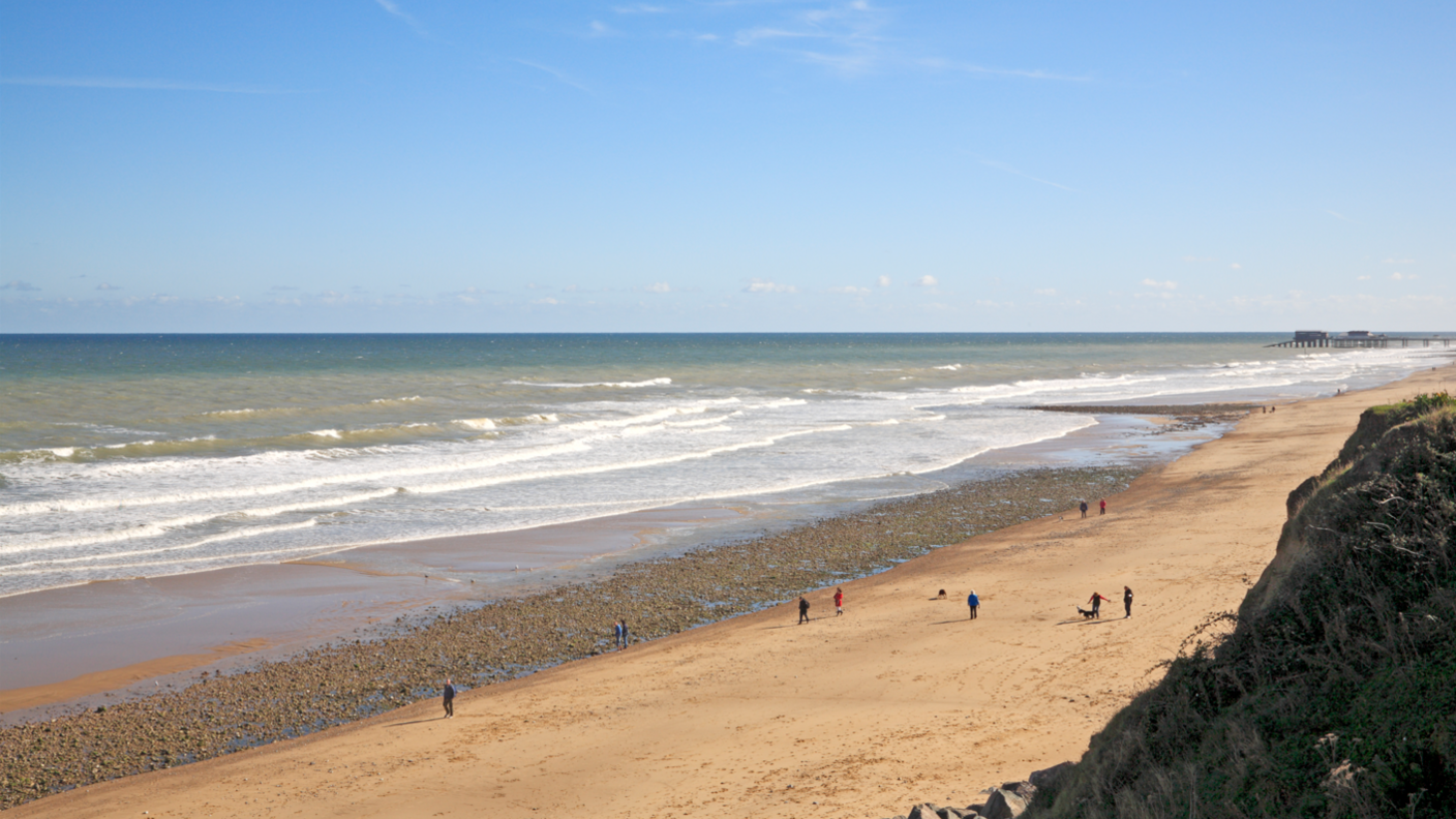 A view of the beach looking towards Cromer at the North Norfolk seaside village of East Runton, Norfolk