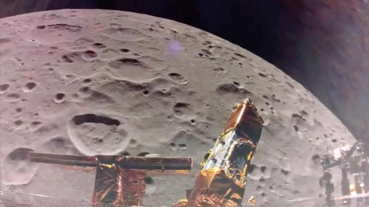 The cratered surface of the Moon seen under the Blue Ghost spaceship as it orbits the lunar surface. The gold foiled legs of the spacecraft can be seen above the Moon.