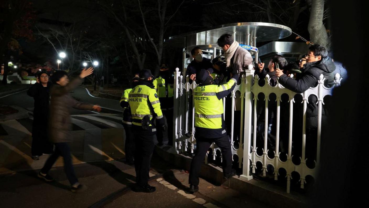 Police officers block the entry to the National Assembly building