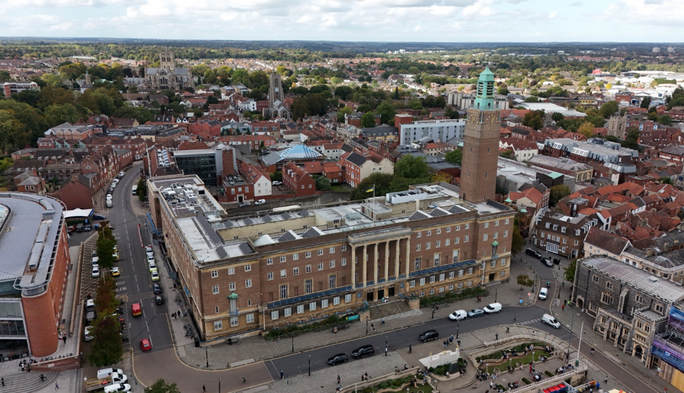 Aerial image showing Norwich City Hall and surrounding buildings, including its clock tower to the right