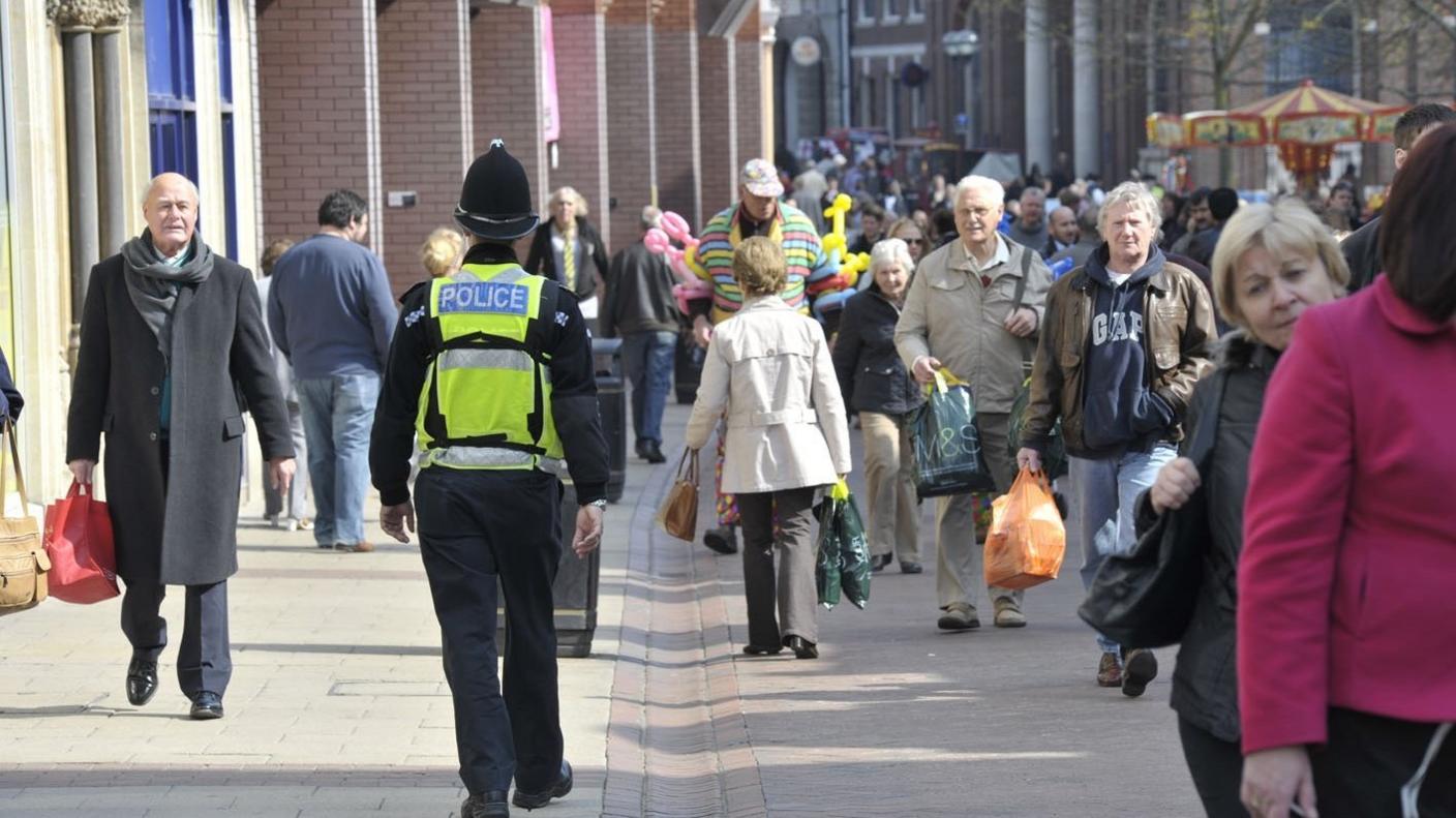 A police officer walking down the street