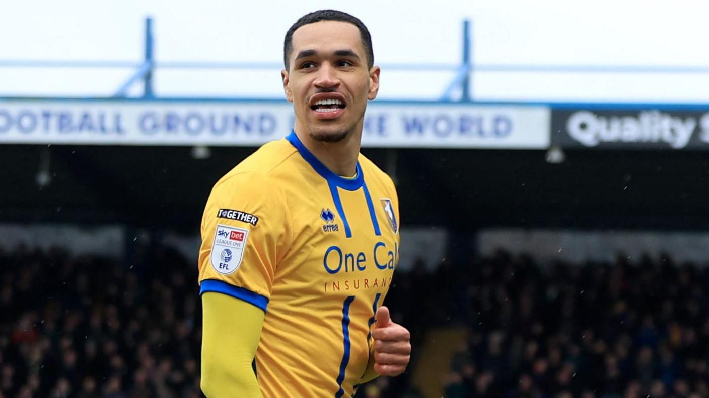 Jon Russell smiles after scoring for Mansfield against AFC Wimbledon