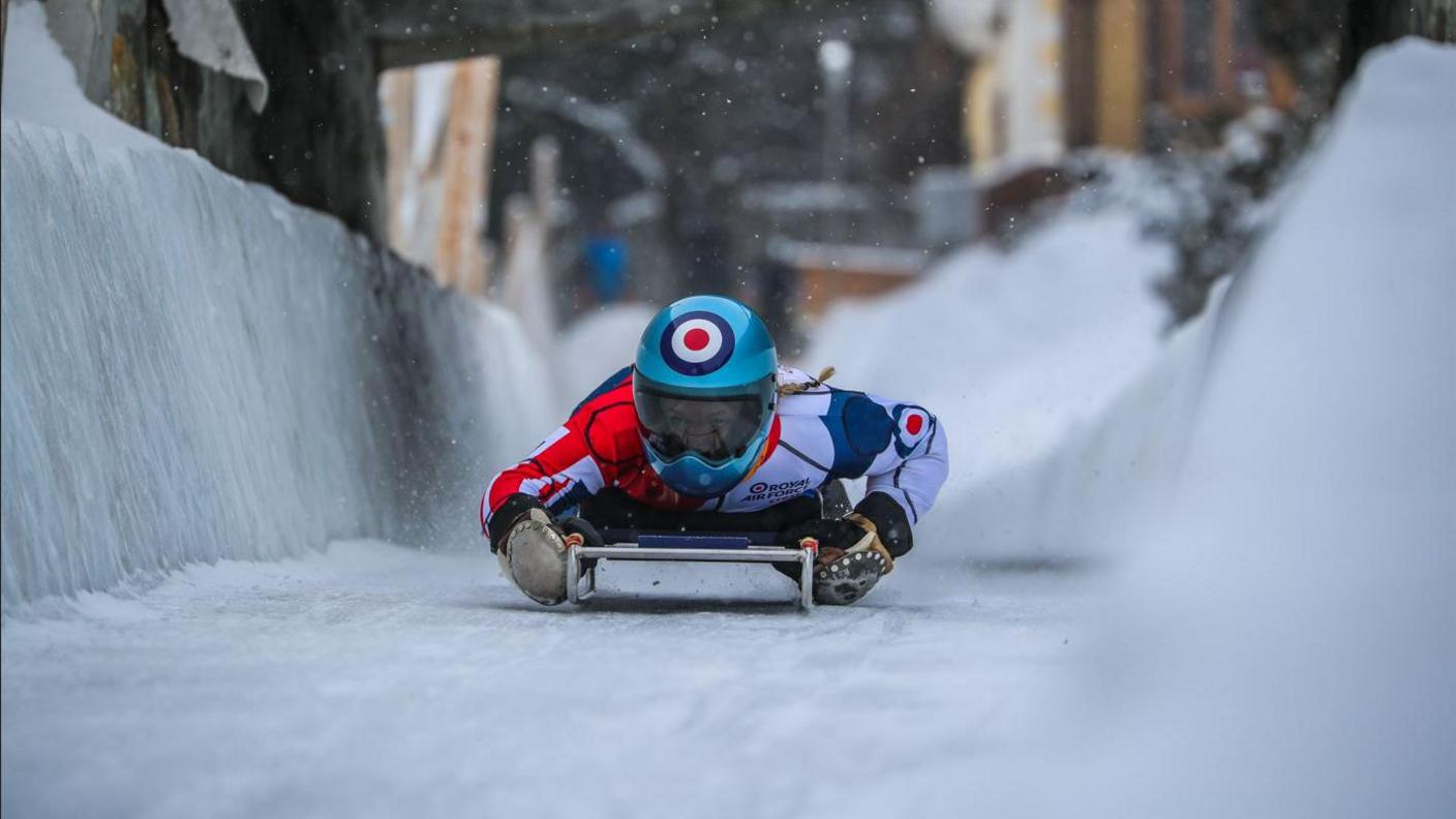 Flight Lieutenant Mimi Hobbs on a toboggan 