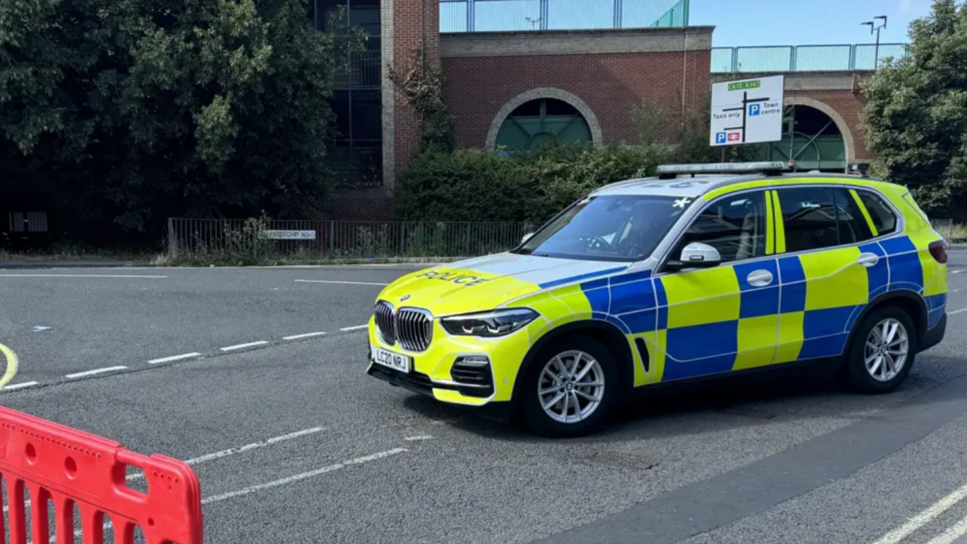 An officer and two police cars at the cordon in Ipswich
