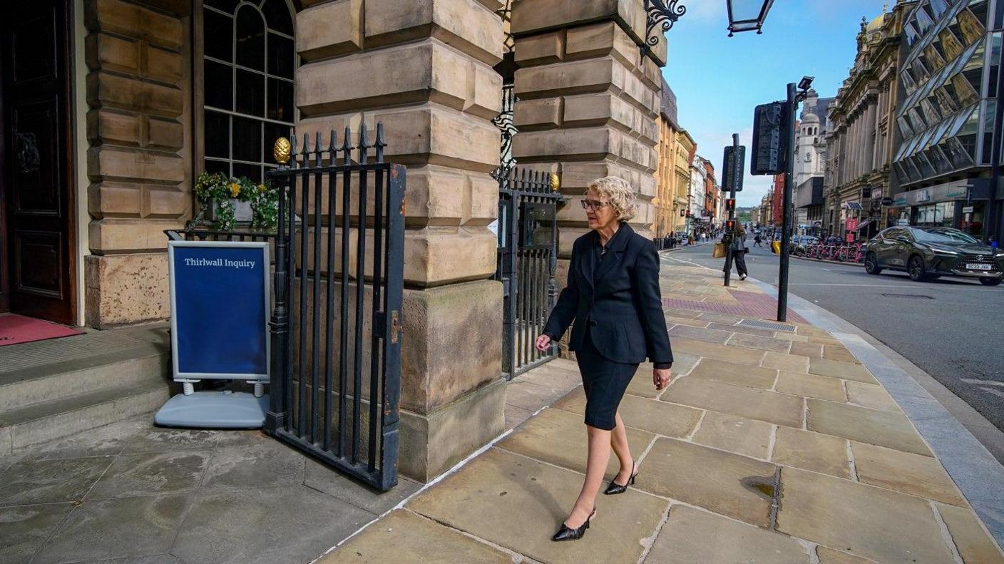 Lady Justice Thirlwall, wearing a black blazer and pencil skirt, arrives at Liverpool Town Hall