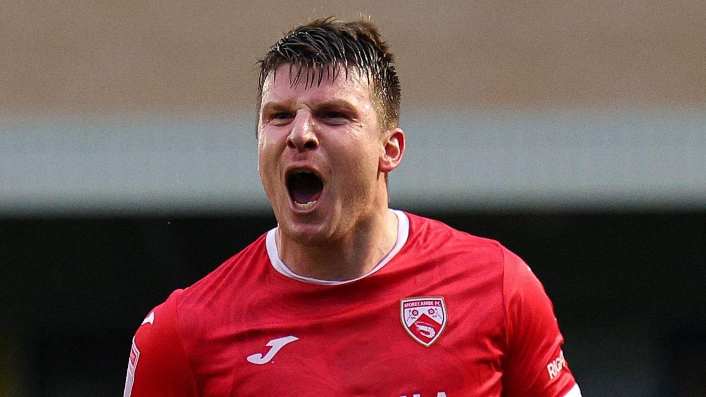 Chris Stokes celebrates scoring a goal for Morecambe