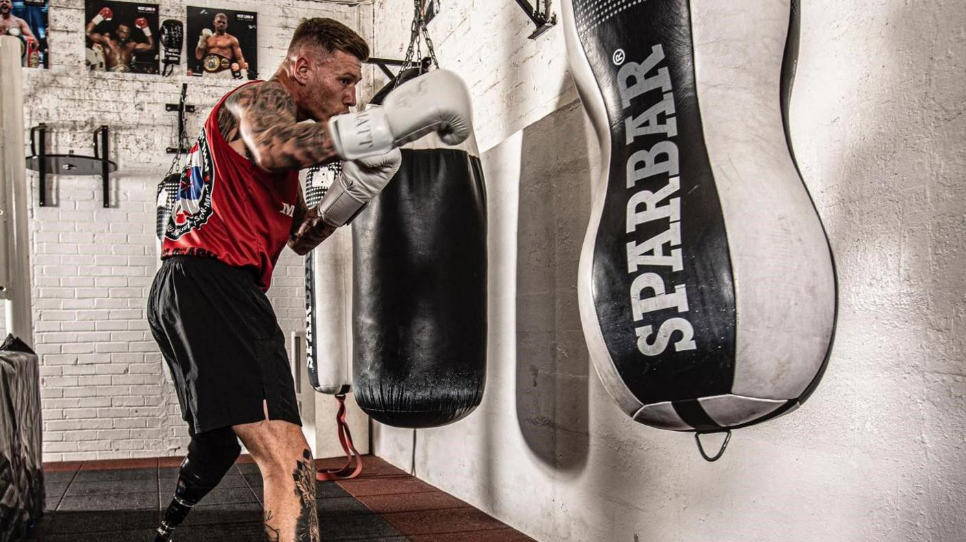 Matt Edwards punching a punch bag