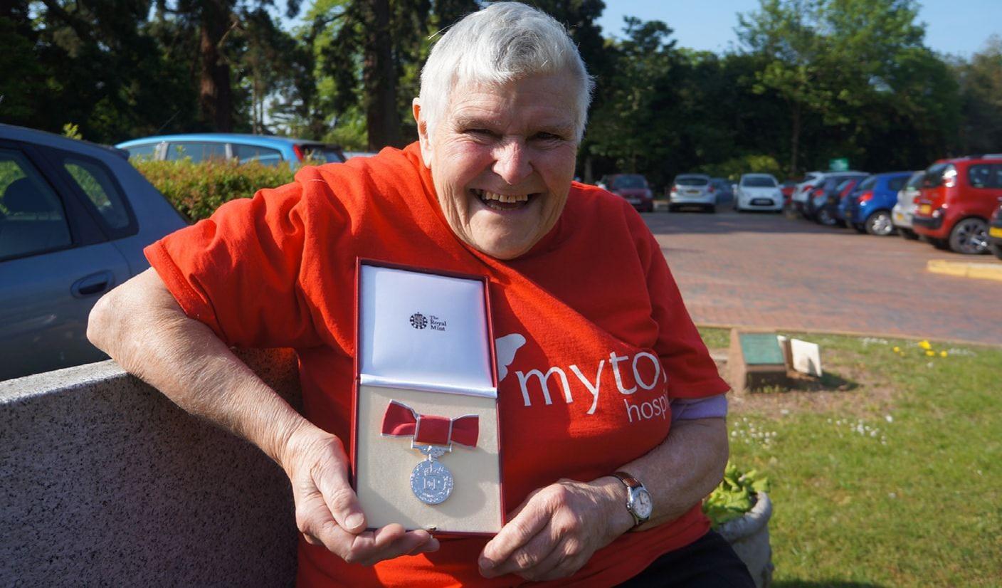 A Myton Hospice fundraiser holding a medal