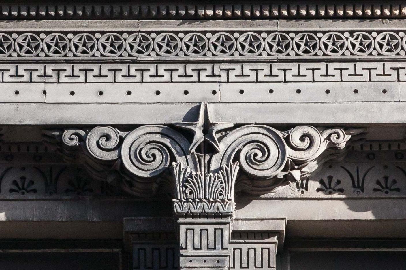 Close up of the intricate design on the sandstone, featuring geometric, swirled and star motifs.