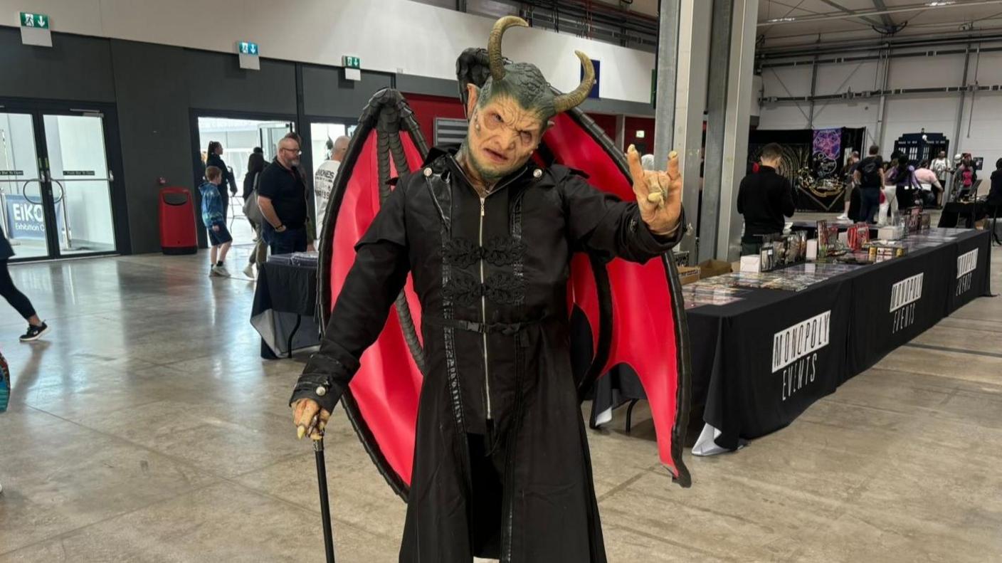 A man dress in cosplay as a demon god known as Akira. 