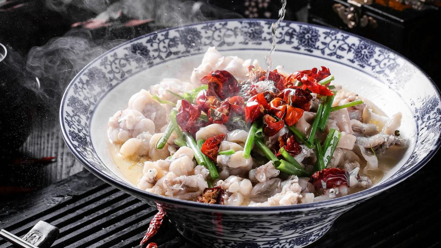 A piping hot Sichuan dish made of fish slices in a hot and sour broth, topped with dried chilli and spring onion 