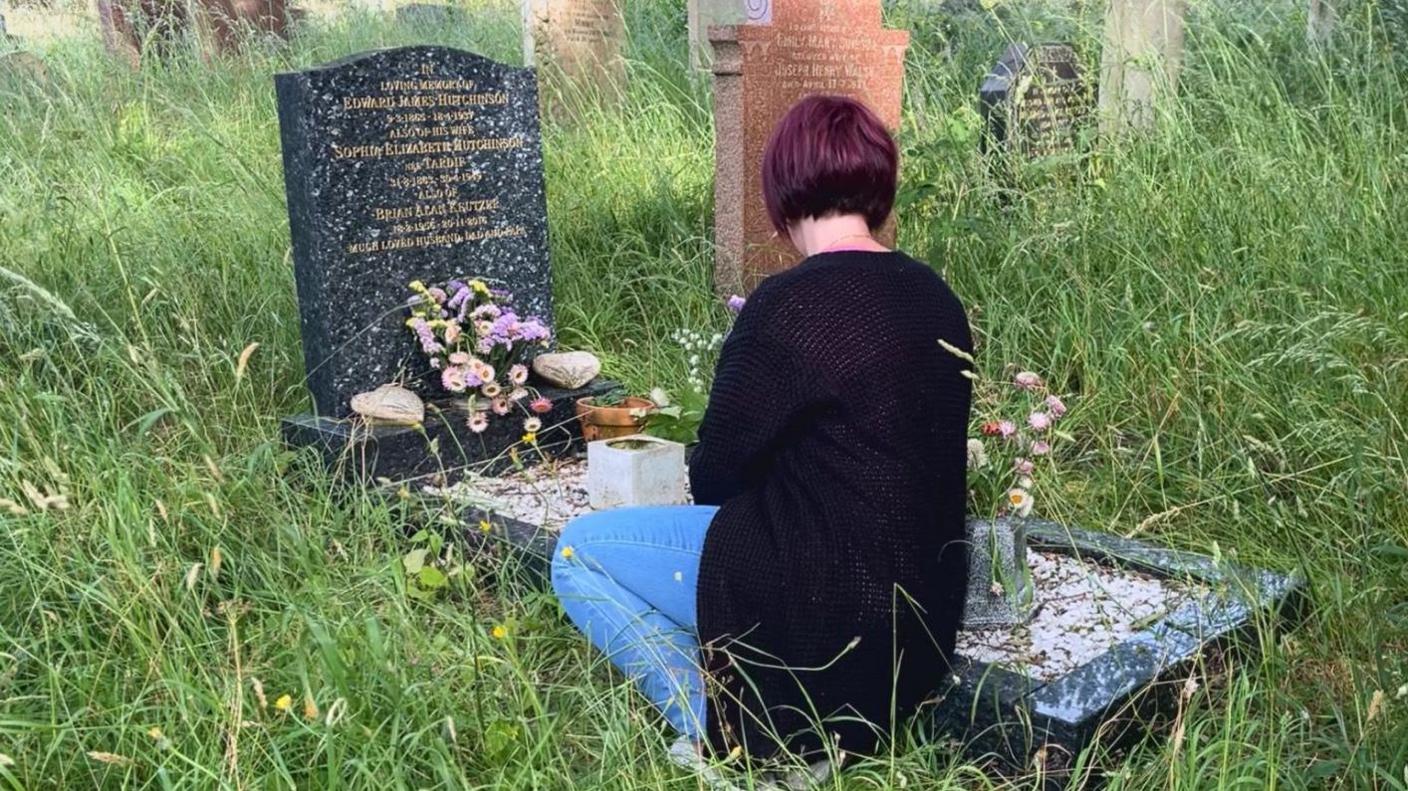 Hayley Baker visiting her father's grave