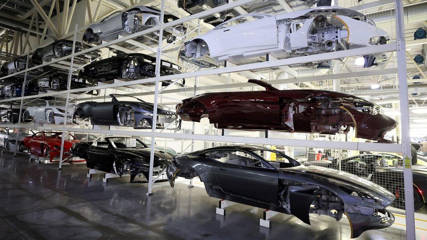 Car bodies are stored on shelves at the Aston Martin factory in Gaydon, Britain
