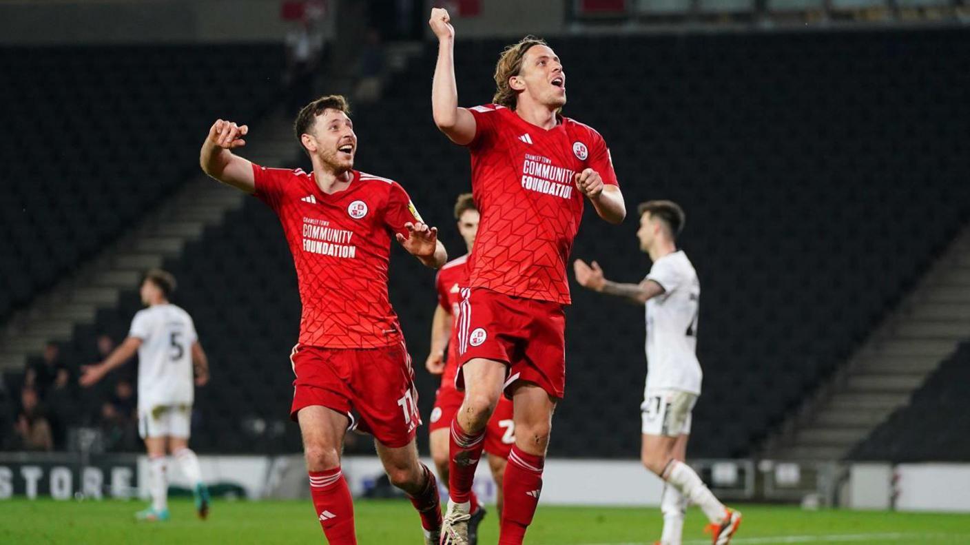 Danilo Orsi celebrates one of his goal in the win over MK Dons, with Jack Roles behind him