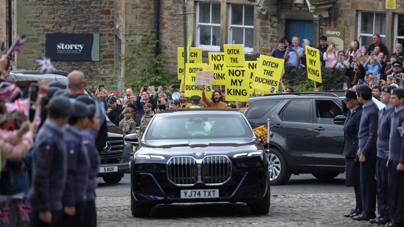 People protest as Britain's King Charles, The Duke of Lancaster, arrives for the Ceremony of the Keys at Lancaster Castle.