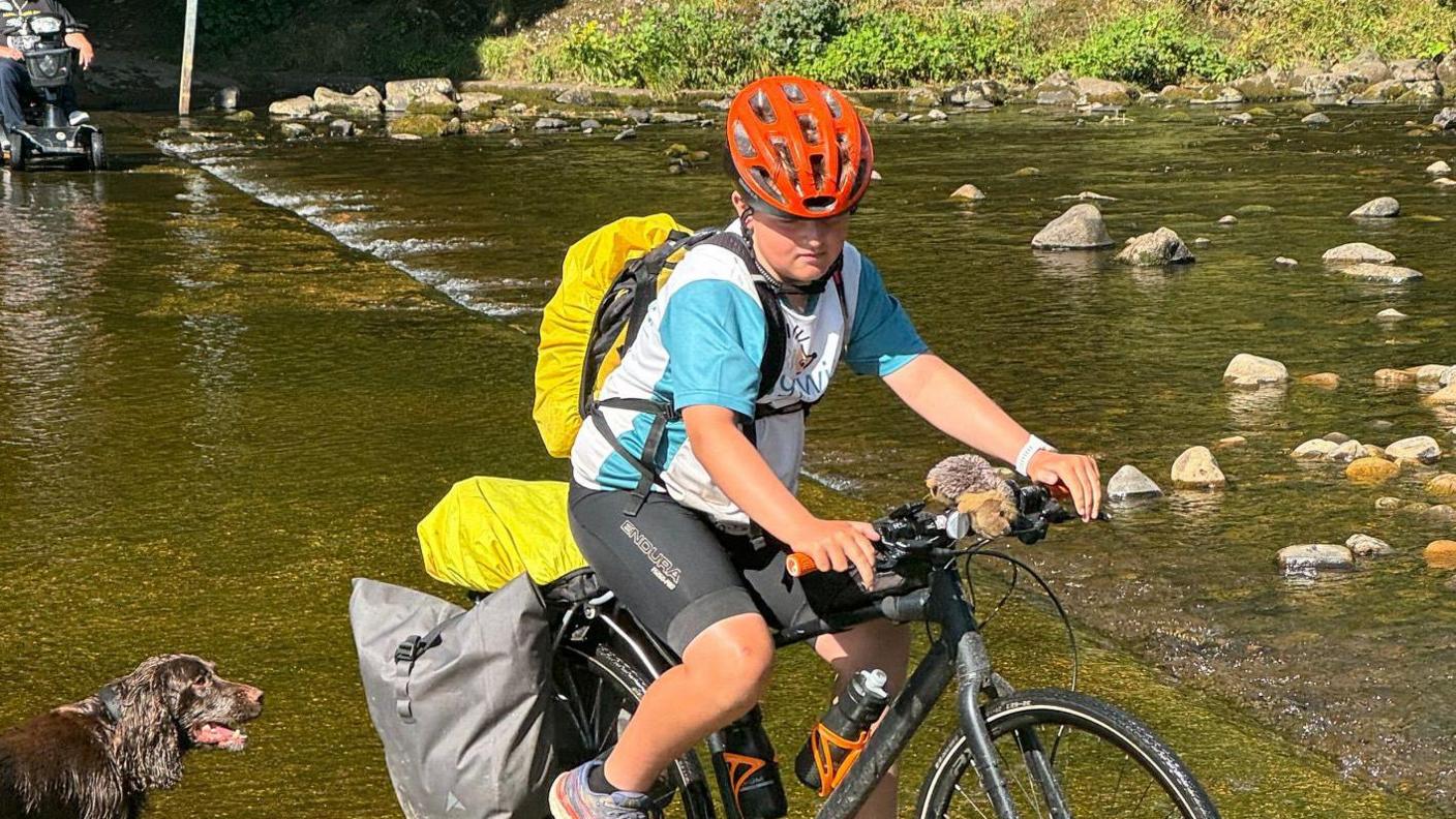 Harry cycling through some water 