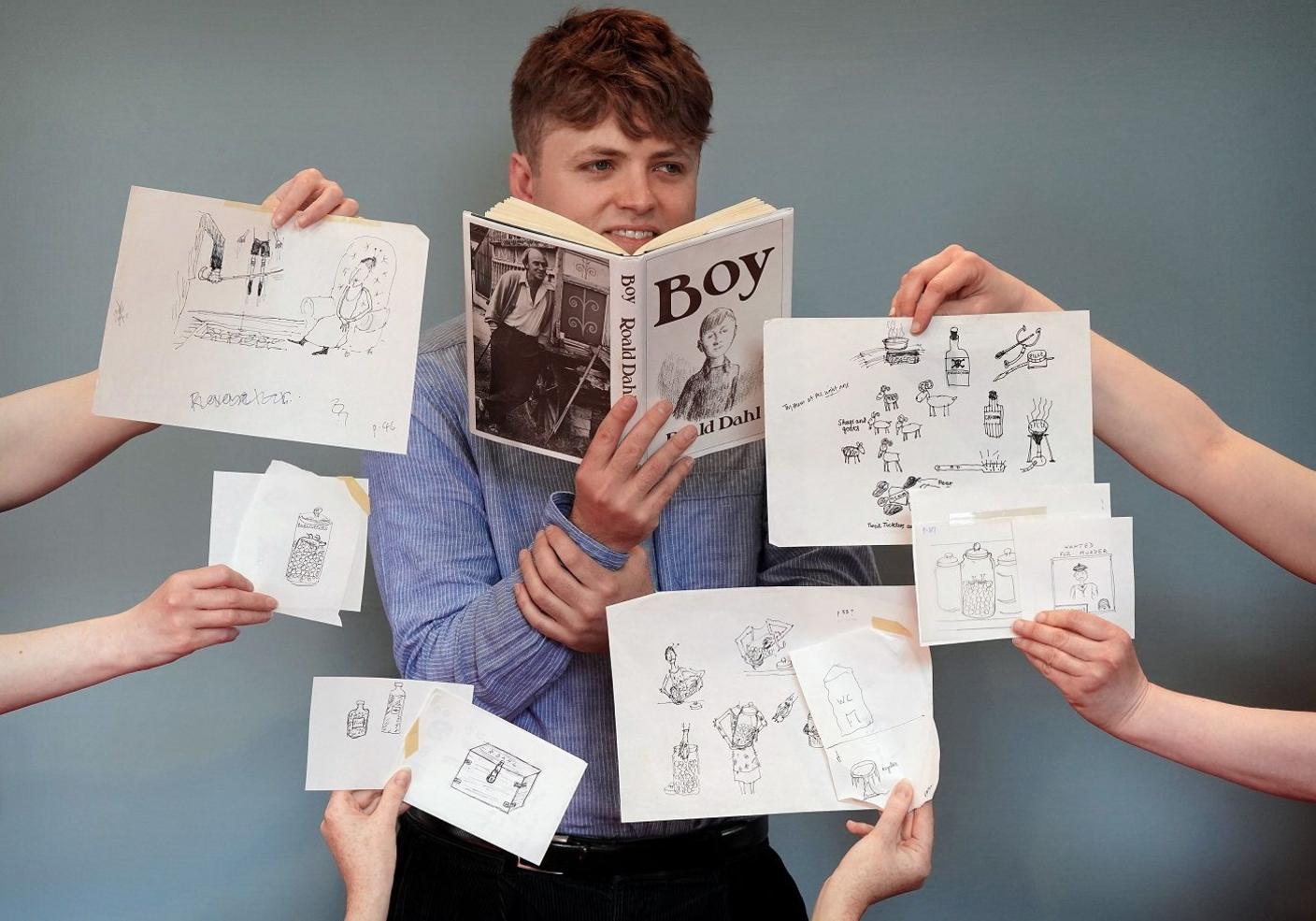 Auction house specialist Dominic Somerville-Brown with items from Roald Dahl illustrations.