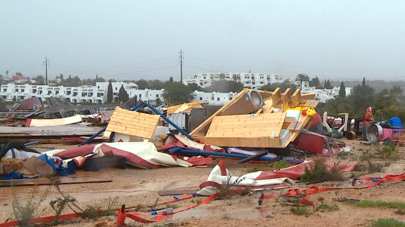 Debris from the storm-hit campsite lies on the ground below a grey sky