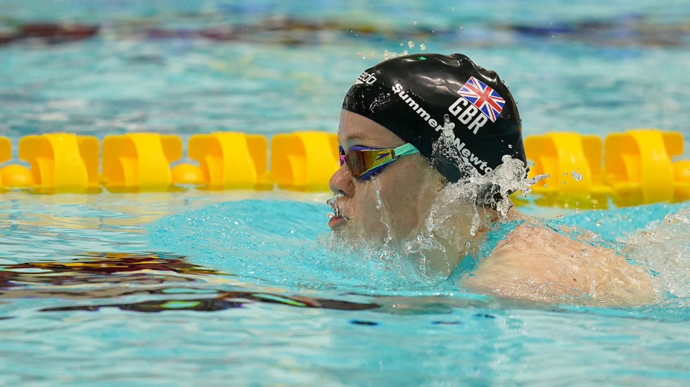 Maisie Summers-Newton competing in the pool wearing a national GB swimming hat