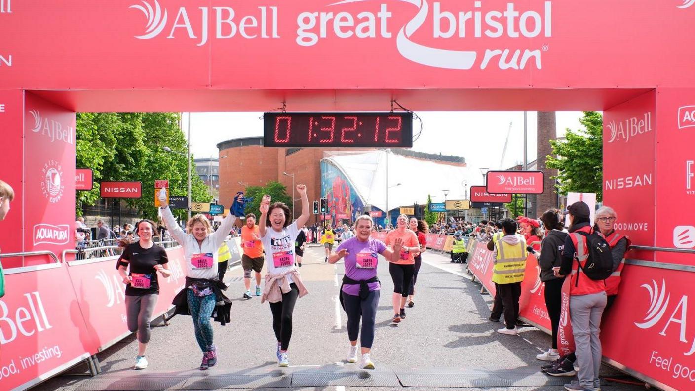 Runners crossing a finishing line 