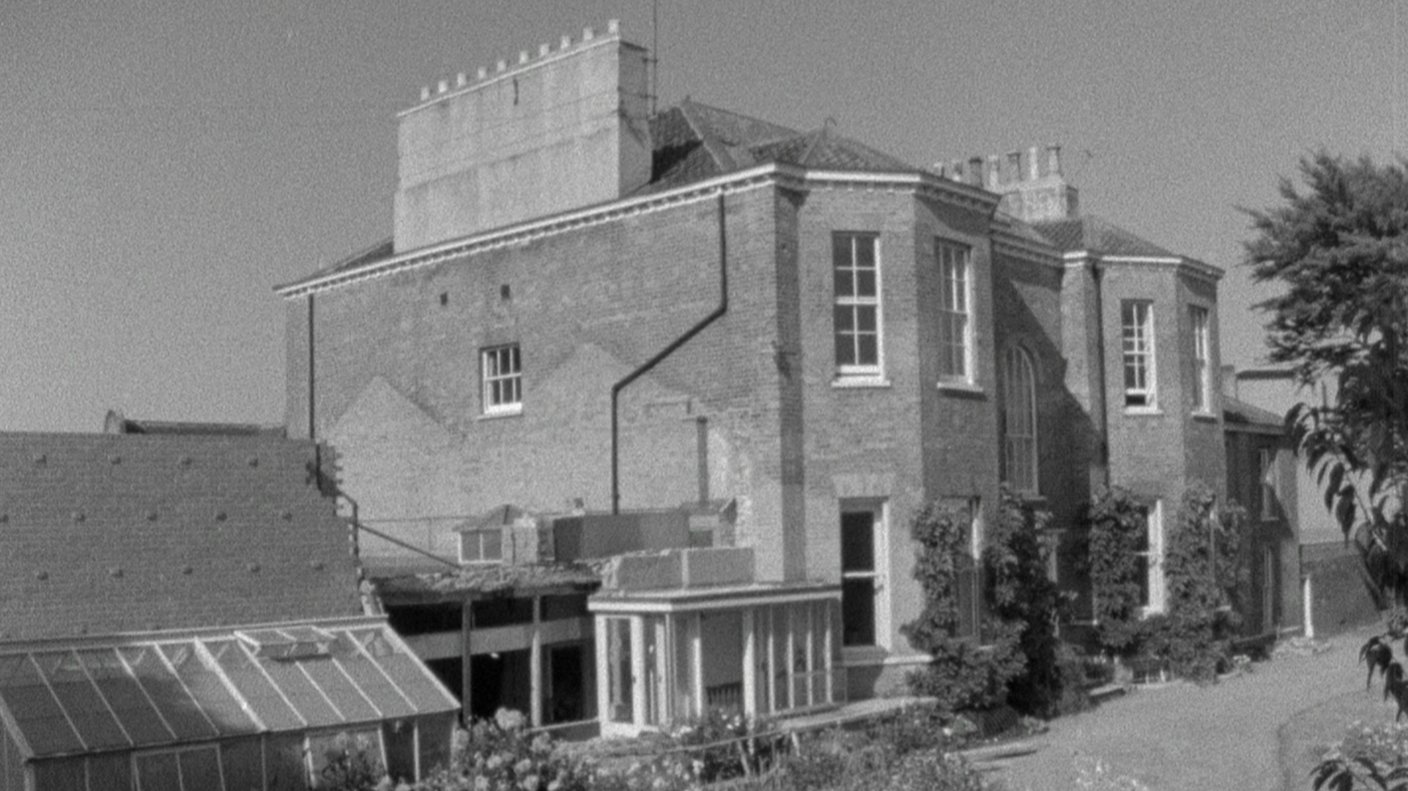 A black and white photo of St Catherine's House, a large historic house, with garden visible in the foreground.