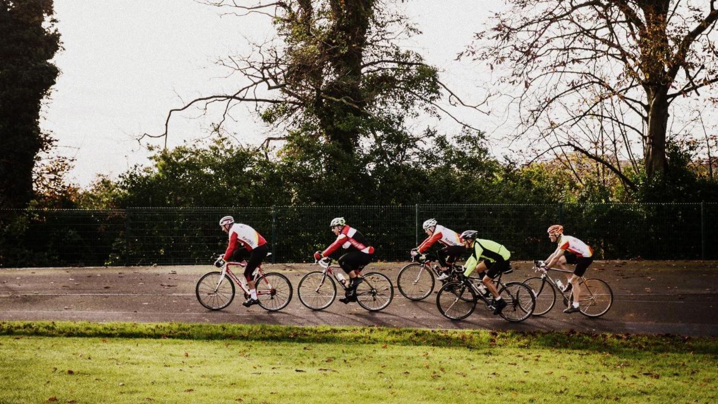 Cyclists on bikes on the velodrome at Preston Park