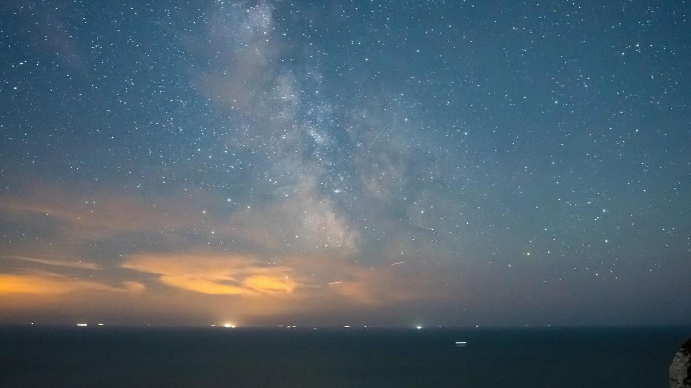 A shot of stars above the sea taken on Beachy Head, East Sussex. 