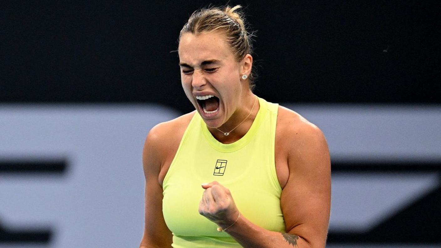 Aryna Sabalenka celebrates with a clenched fist