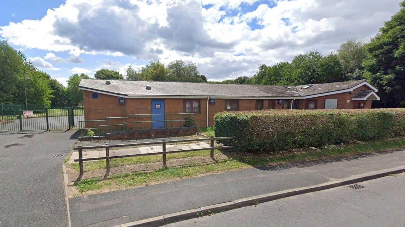 The former offices in Rough Hills Road, Wolverhampton, with a pavement in the foreground