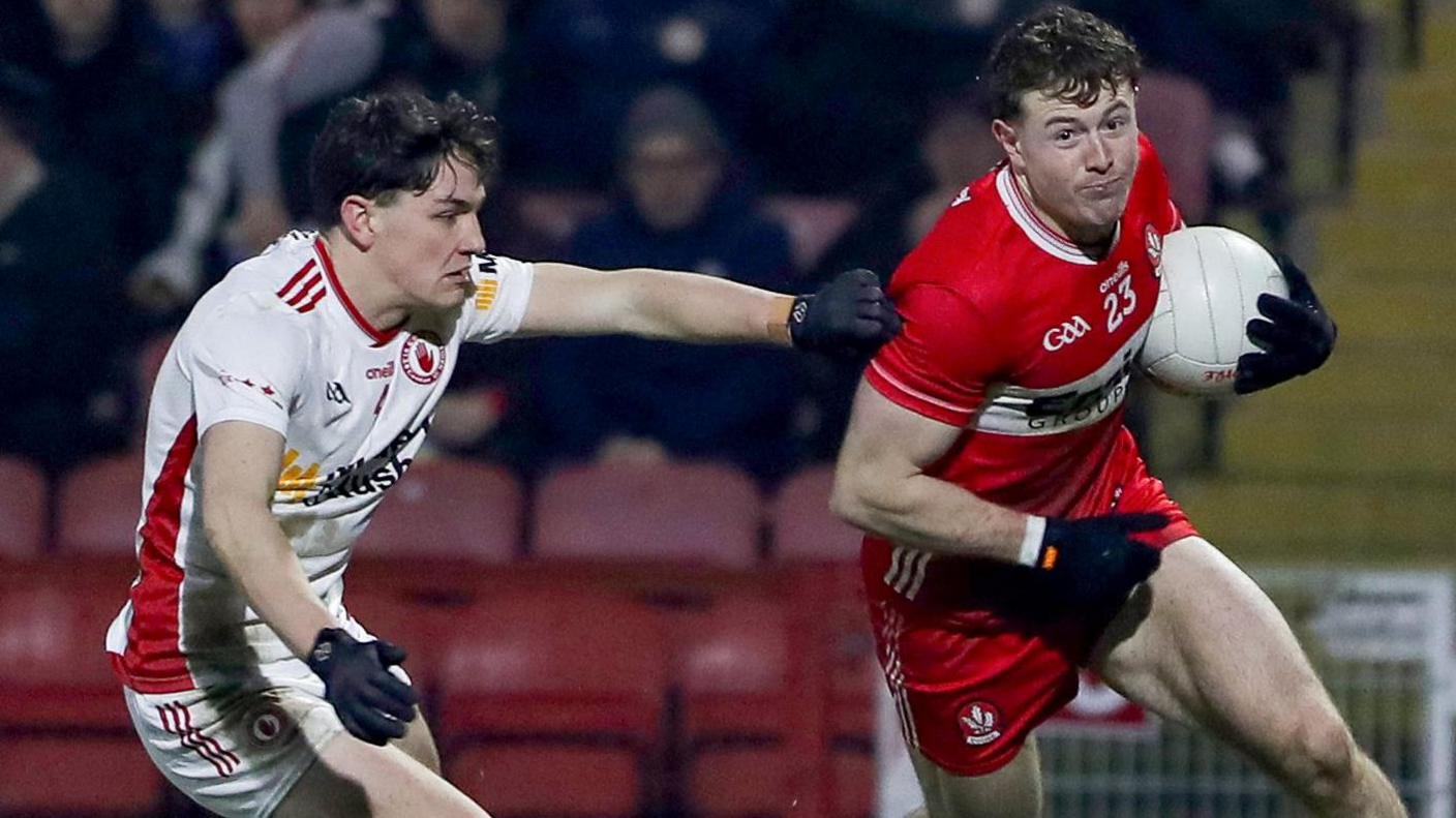 Derry's Lachlan Murray gets away from Tyrone's Joey Clarke 