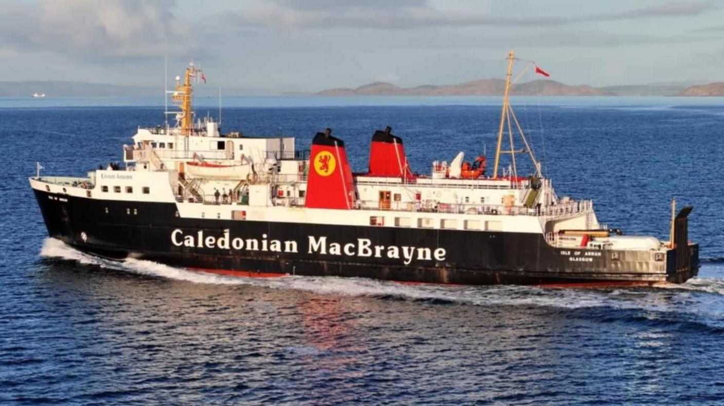 A black and white ship with red funnels. The ships has a dated appearance. 