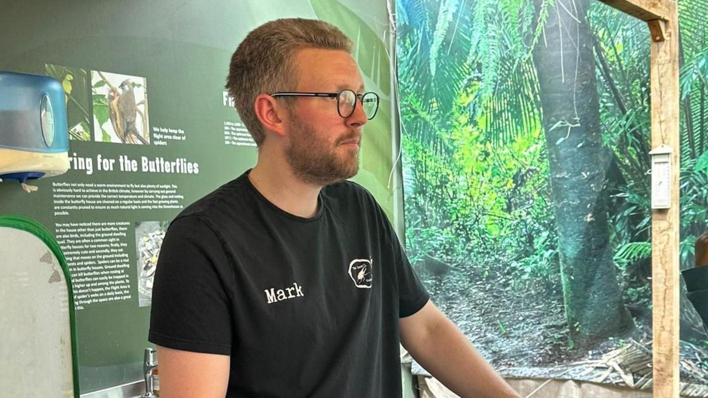 Mark with cases of beetles at a talk 