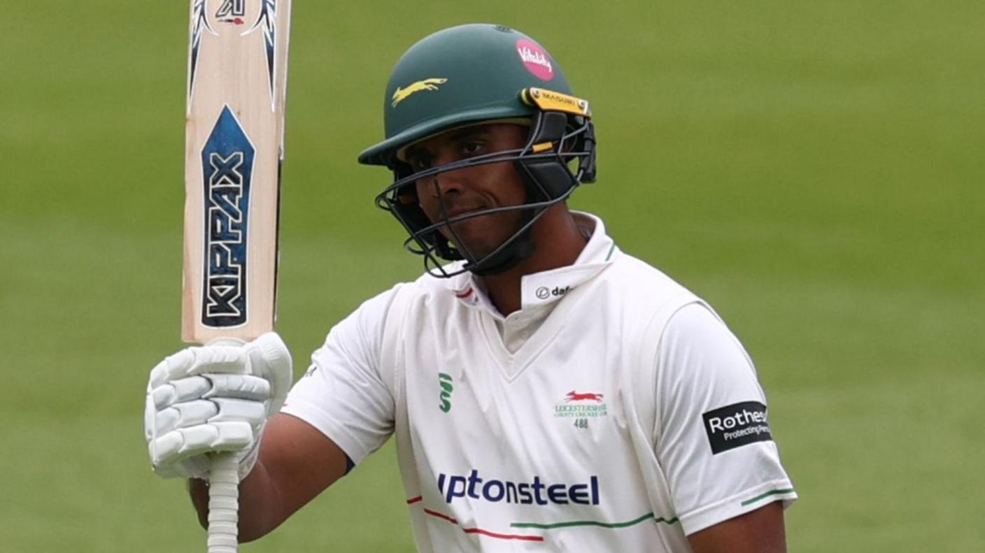 Rishi Patel raises his bat after reaching his 50 against Sussex