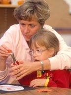 A girl with learning difficulties and her teacher (Science Photo Library)