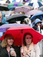 Crowds under umbrellas at Queen's