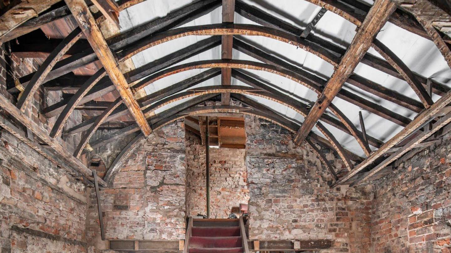 Interior view of the inn at first-floor level, showing the frame supporting the barrel vaulted roof.