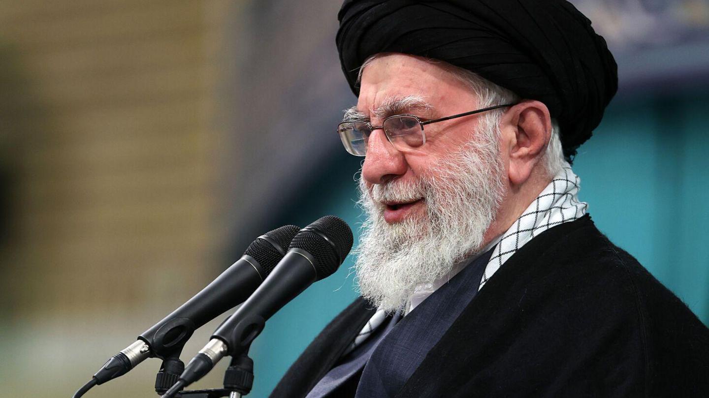 Ayatollah Ali Khamenei speaking into a microphone