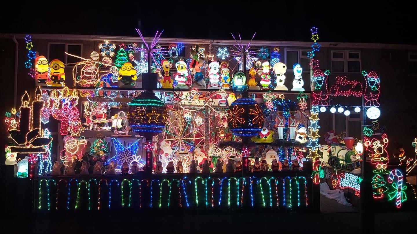 Boscombe Road in Swindon. A house is covered in Christmas lights and decorations. Disney characters like Mickey Mouse and Olaf can be seen, as well as Minions and the Grinch. 