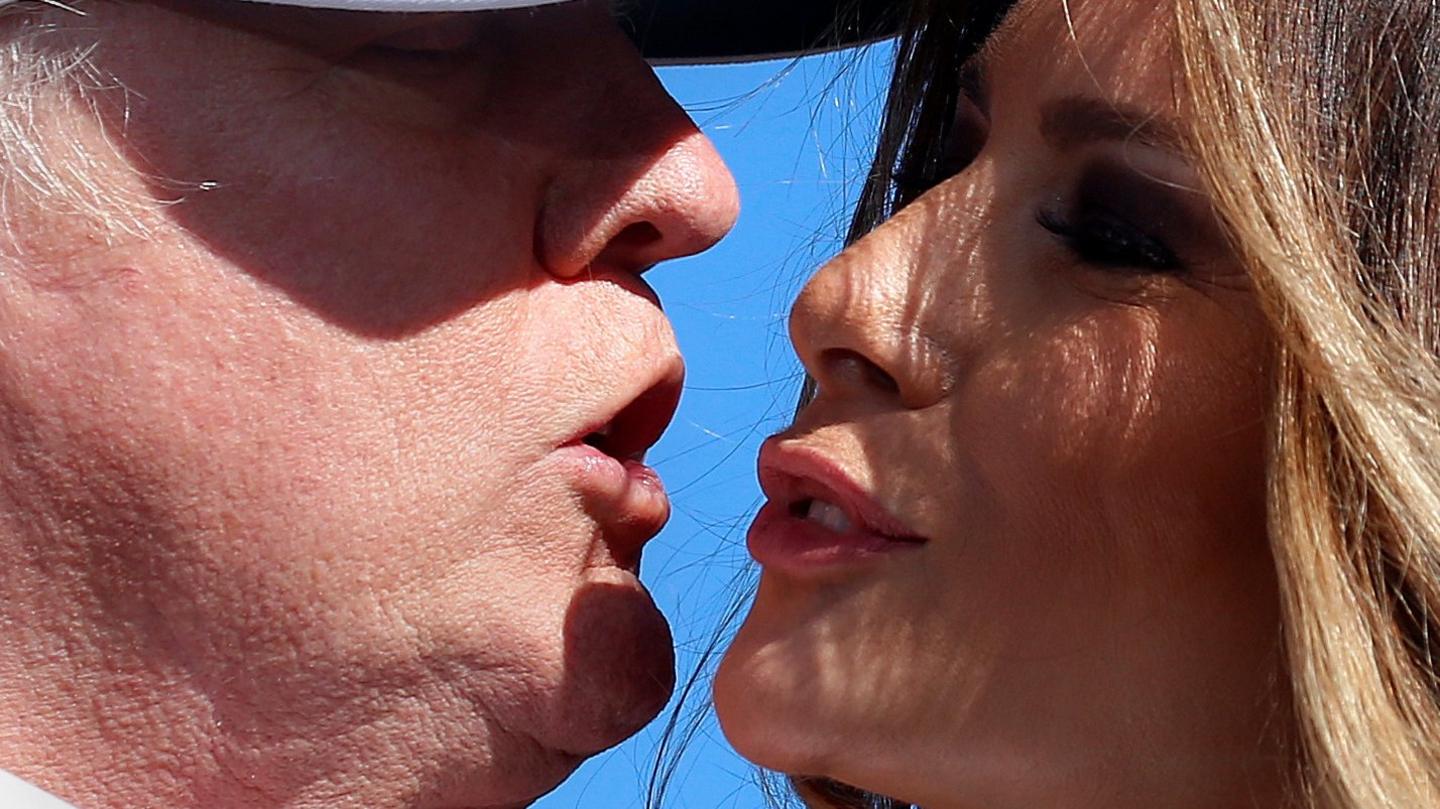 Donald Trump kisses his wife Melania Trump at a campaign rally in Wilmington, North Carolina