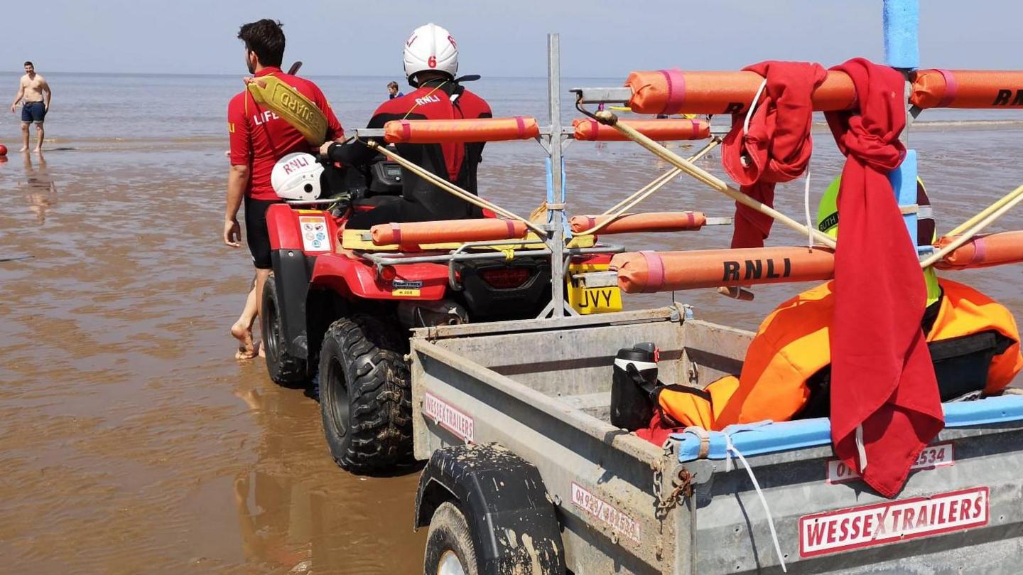 lifeguards on patrol on a beach