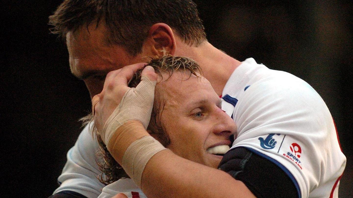 Rob Burrow and Kevin Sinfield embrace after a try while playing in an international match