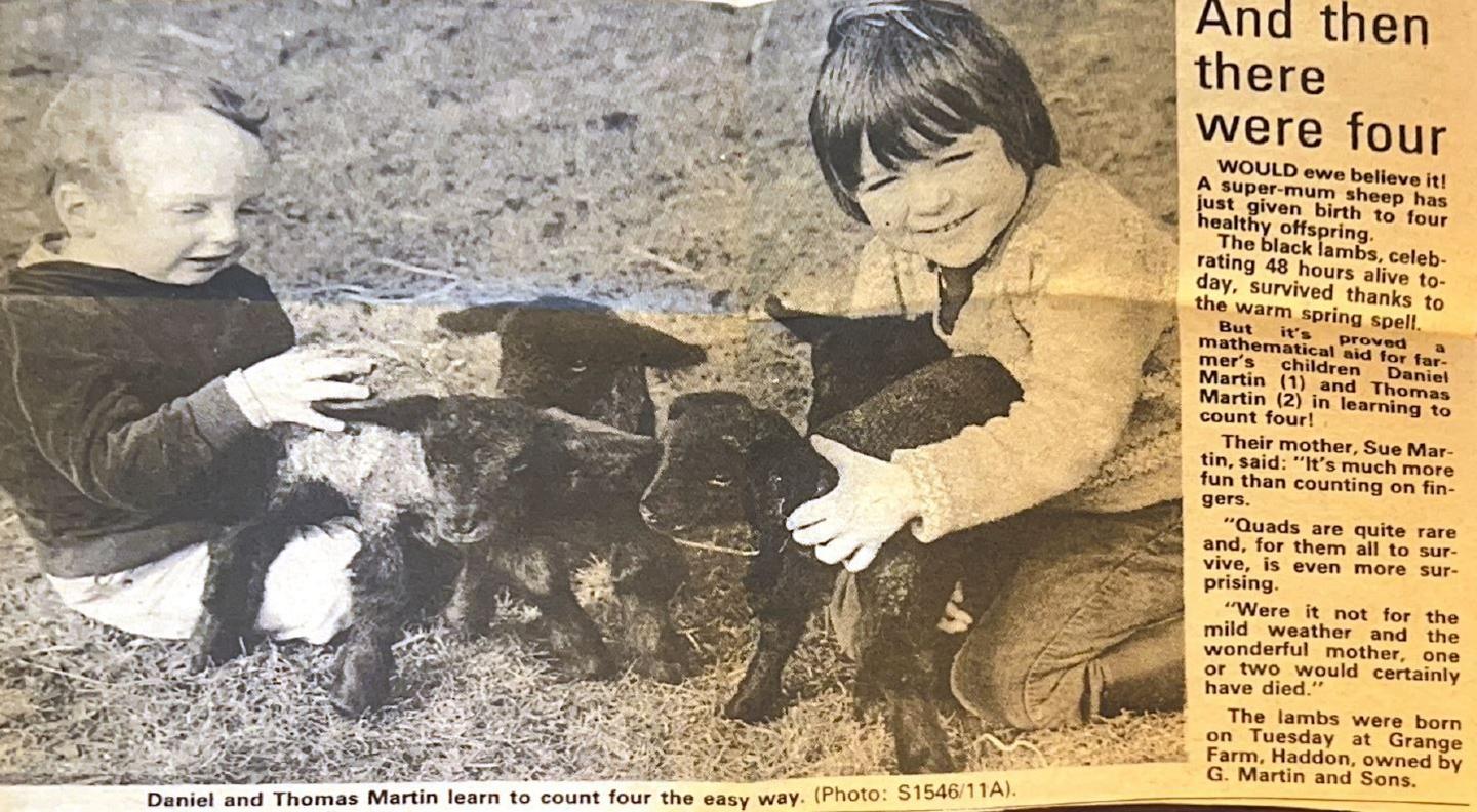 Daniel and Tom Martin as young boys holding four lambs