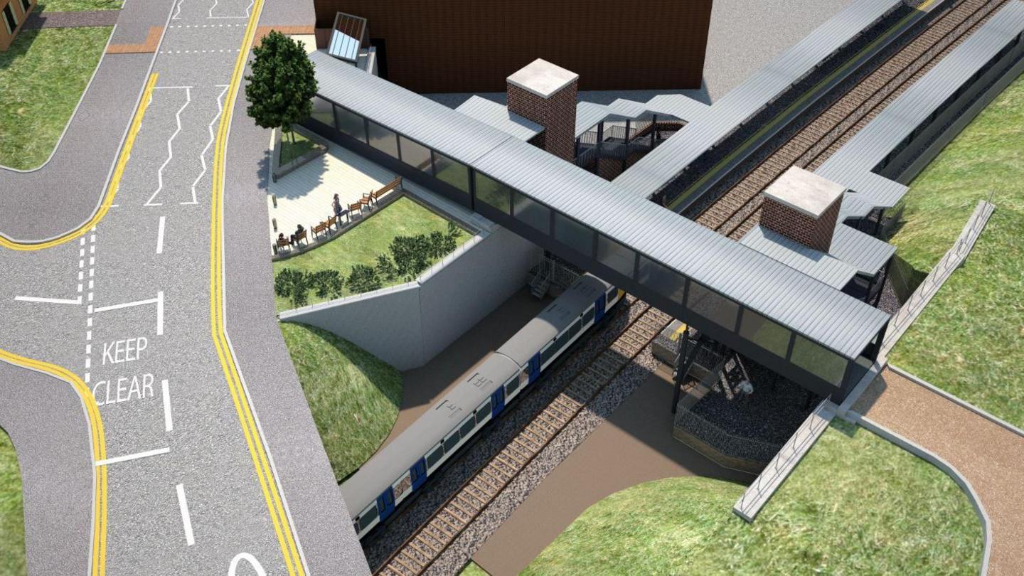 An aerial drawing of a railway station with a road running alongside it and a covered bridge running over the track