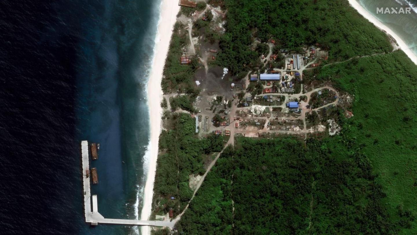 Close up satellite image of the jetty with ships alongside it; the image also shows development on the island