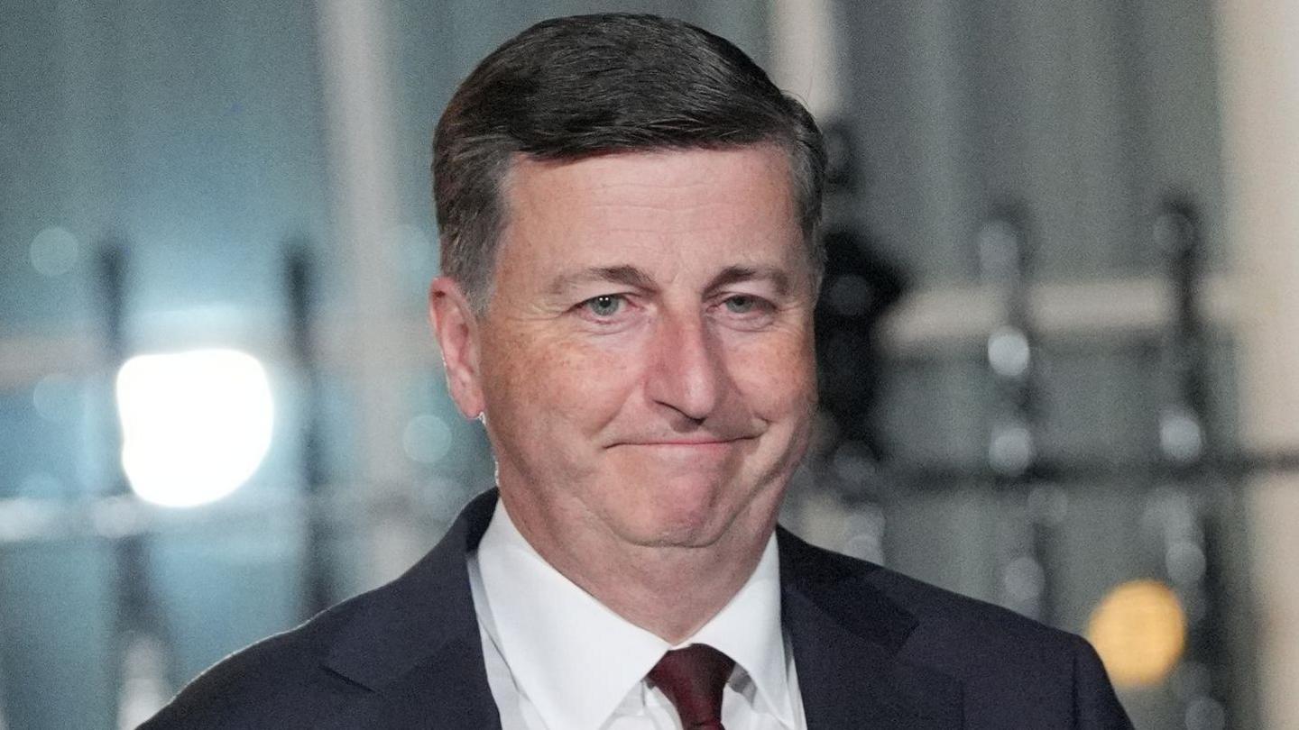 Douglas Alexander has short grey hair and wears a dark suit